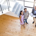 Real estate agent showing new house to couple